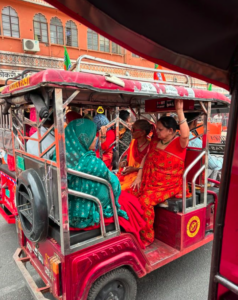 Passengers in a Pink City Rickshaw