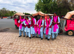 A team photo of The Pink City Rickshaw female drivers