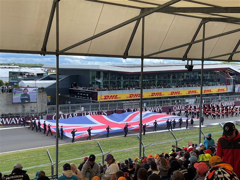 A picture of the the union jack being carried on a race track